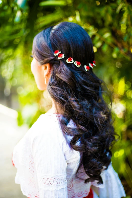 girl with long hair in the woods wearing flower headpiece