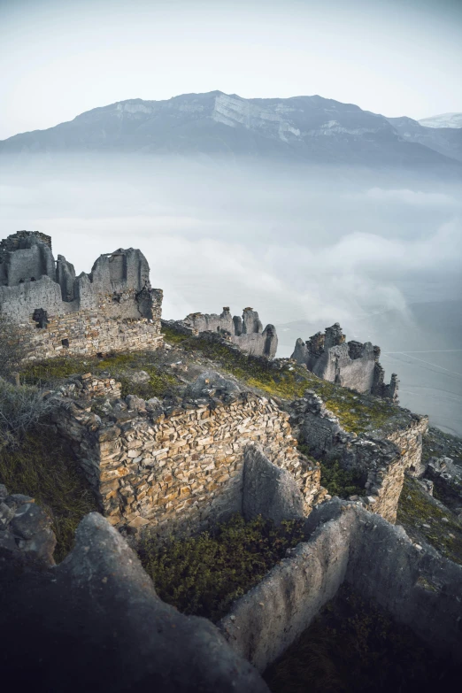 a stone castle is in the middle of the landscape