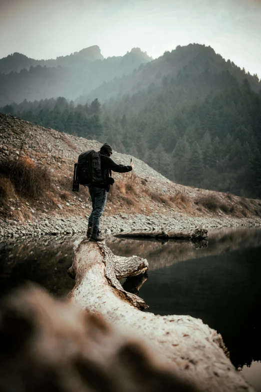 a person wearing a backpack walking across a body of water