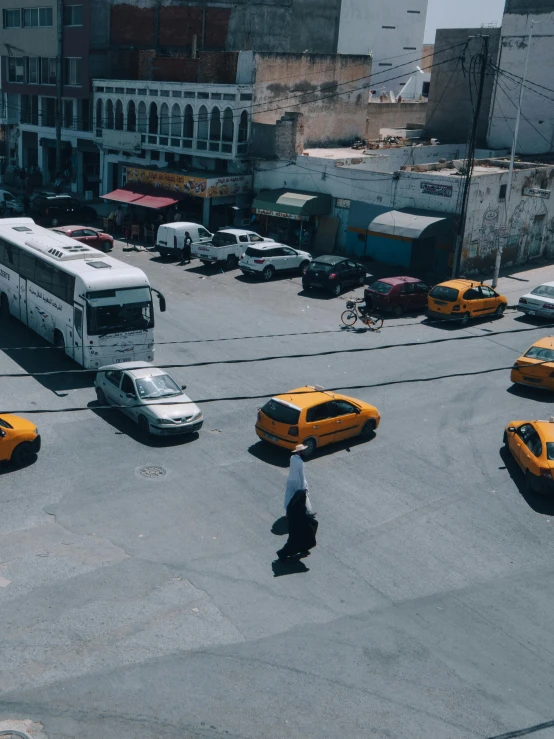 taxi cabs parked in a parking lot next to buildings