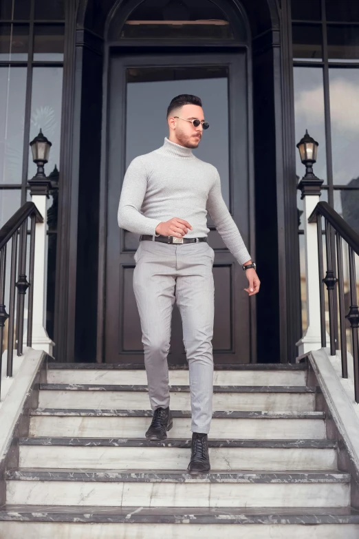 a man in a silver suit standing on steps