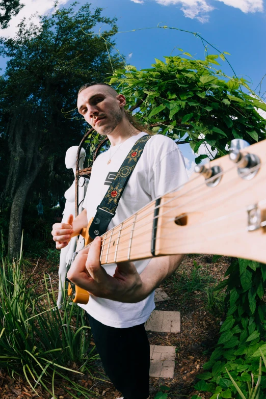 the person is playing an electric guitar on a field