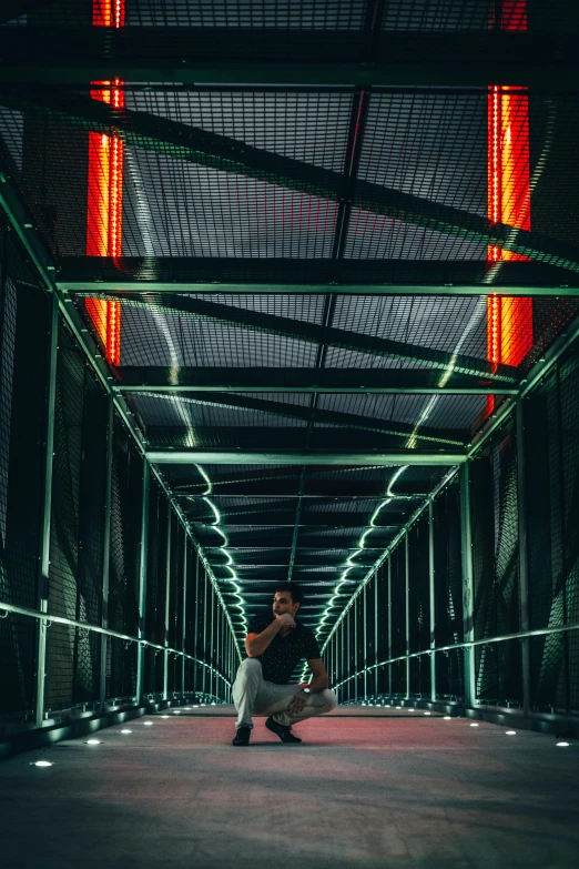 a woman sits on the ground in a dark tunnel