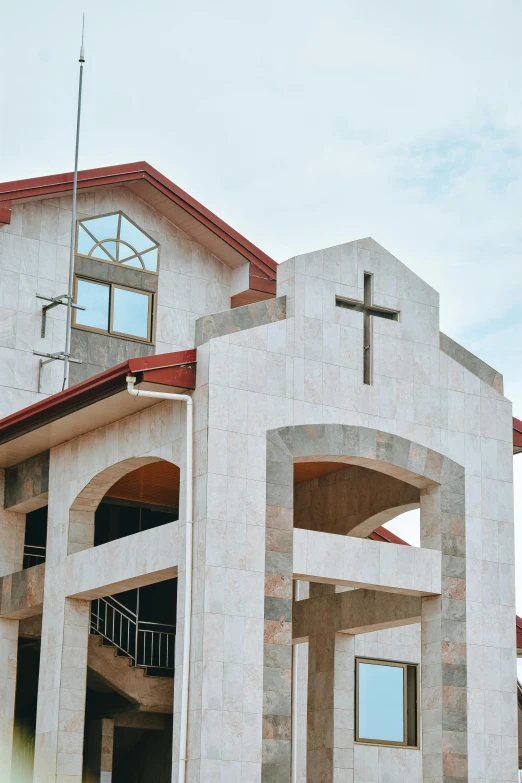 a building with a steeple on top with a cross on top