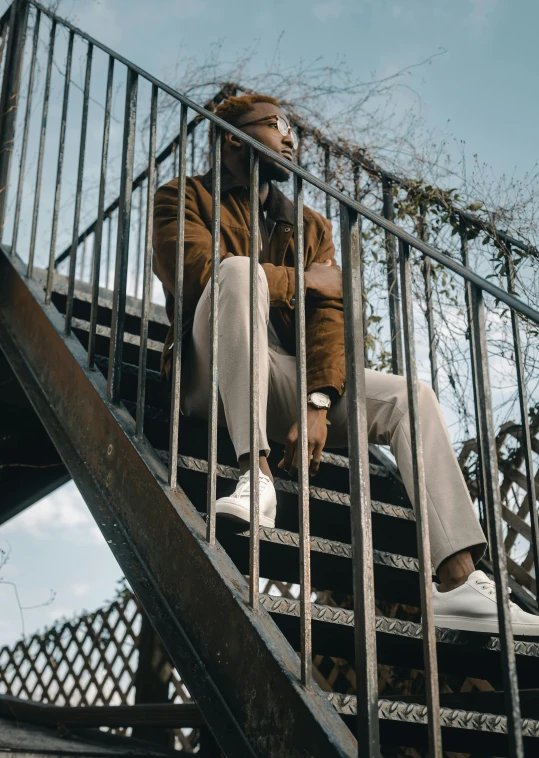 a person sitting on some steps while holding a skateboard