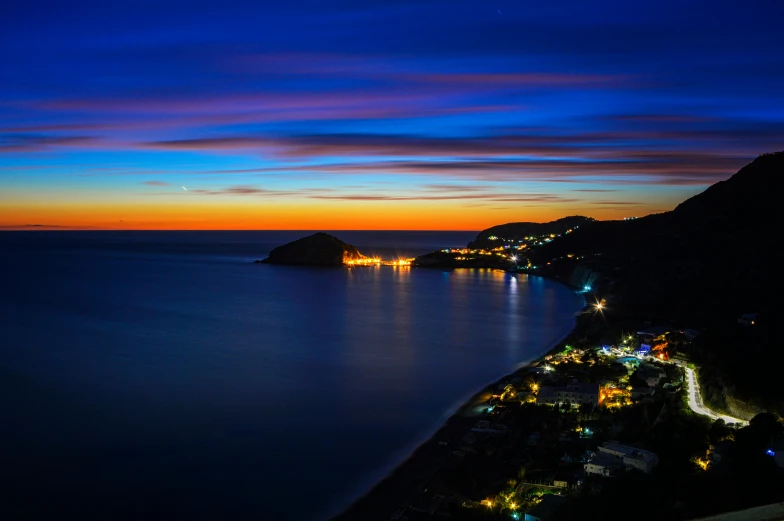 the city lights by the sea in a city at night