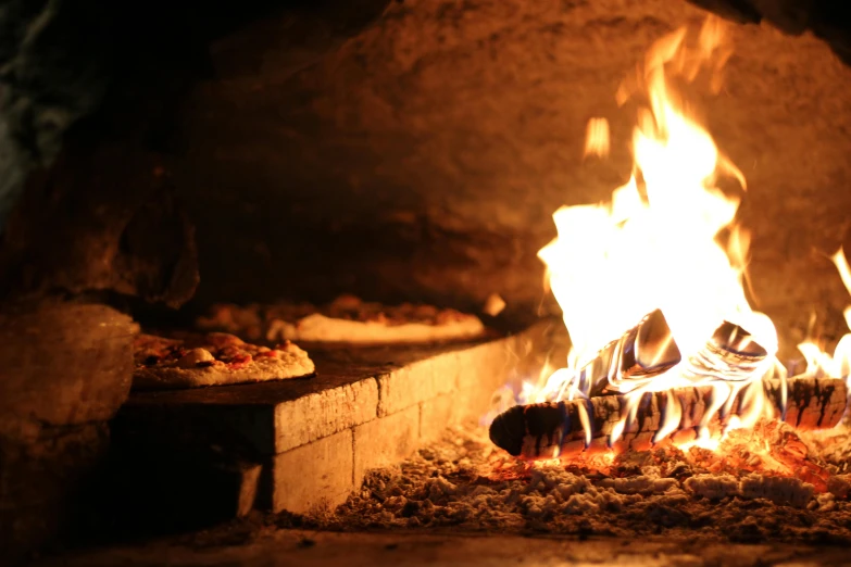 pizzas and fire in the oven with a bright light