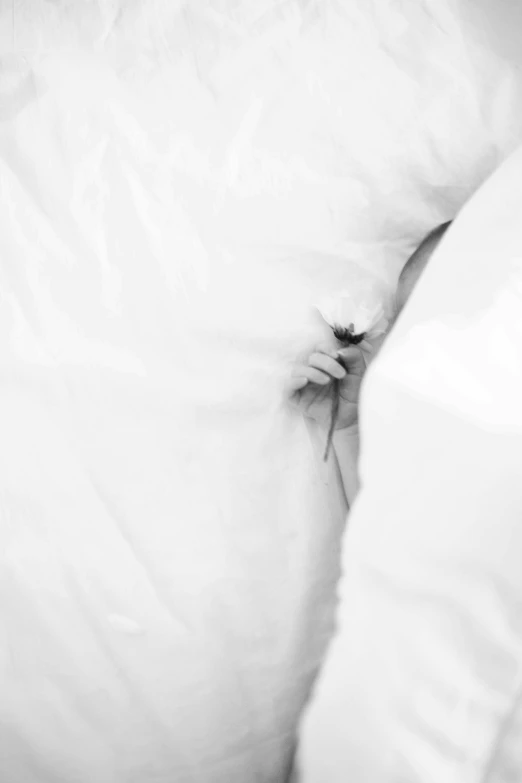 a black and white po of the corner of someone's bed