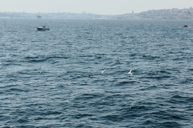 two boats out on the ocean with their tops turned down