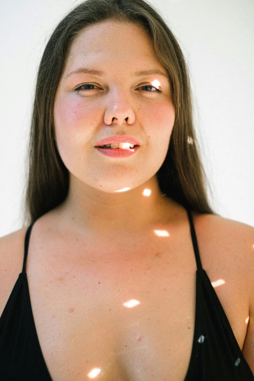 a girl in a bikini has very small circles of light on her 