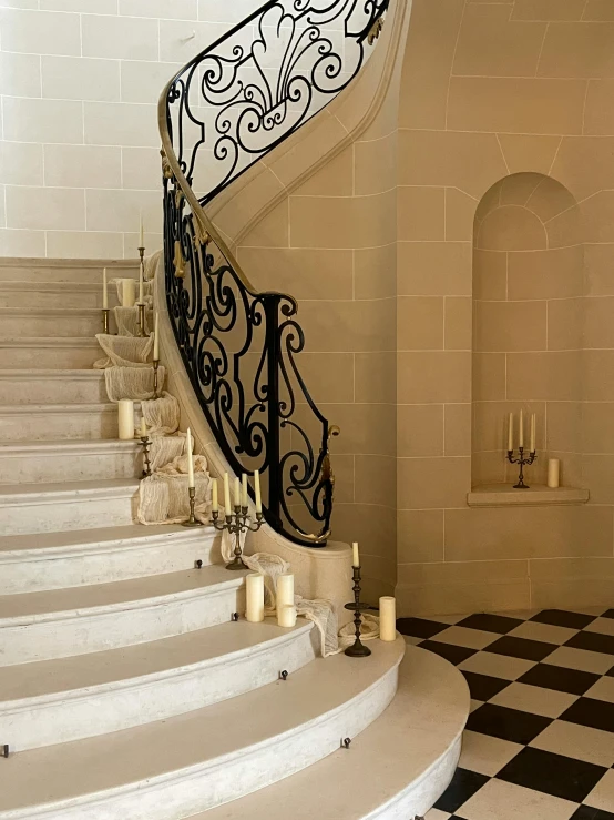 a staircase and a marble tile floor in a large home