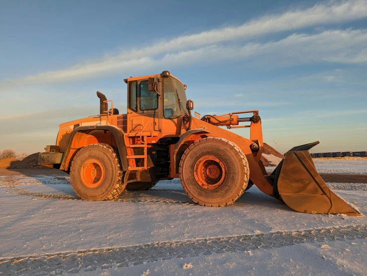 a large truck driving down a snowy road