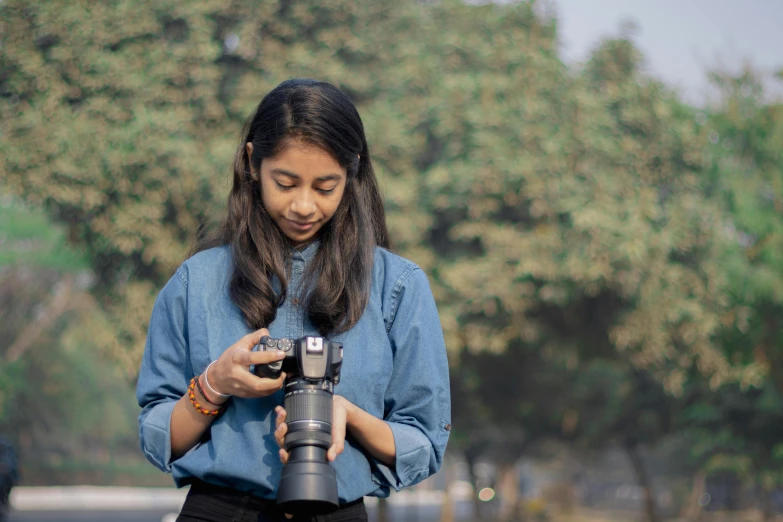 a woman with long dark hair taking a pograph