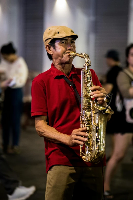 a man in red shirt playing a saxophone