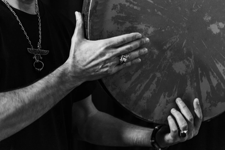 a close up of a man holding his hands near a frisbee