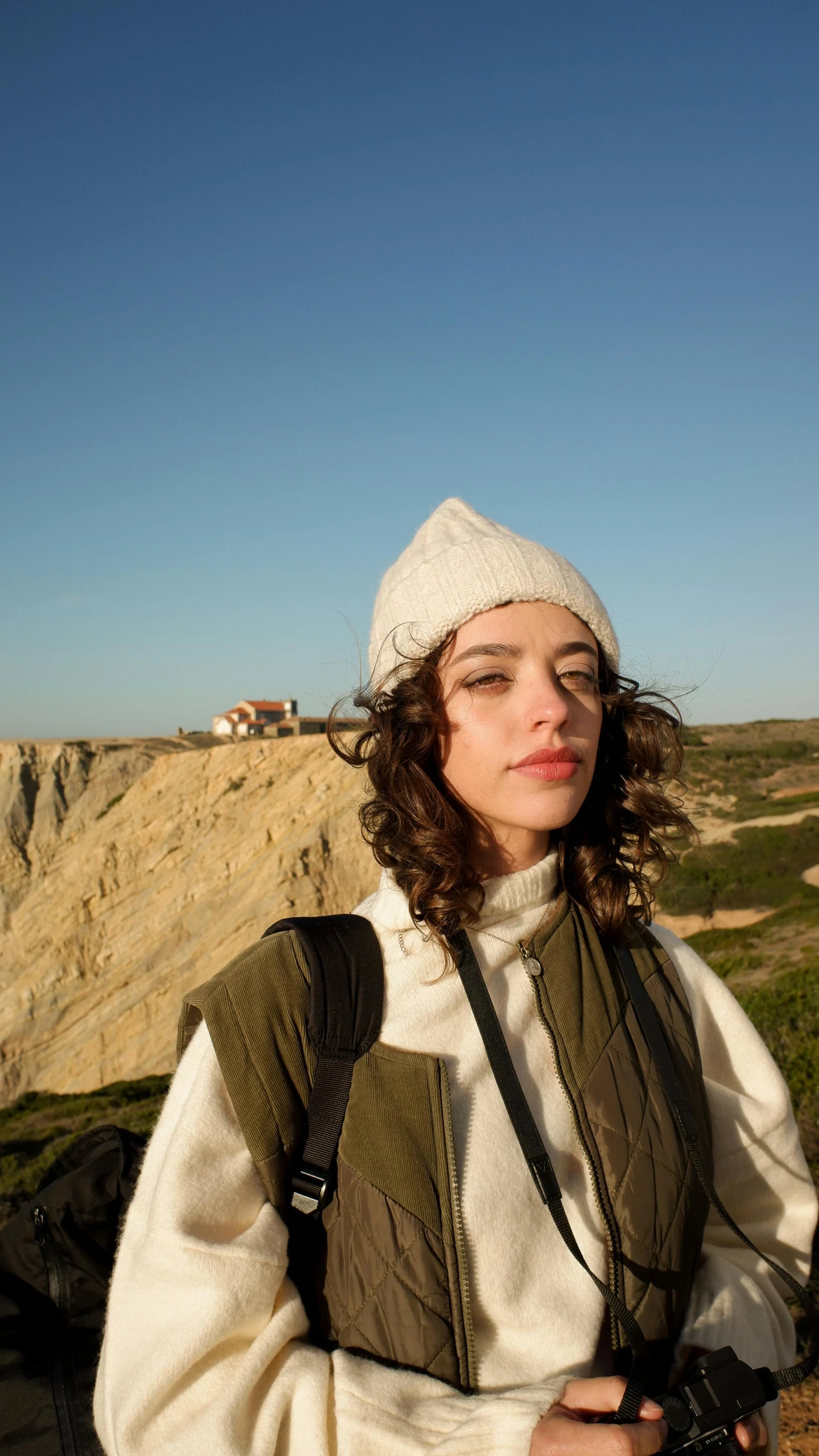 a woman with a camera taking a selfie on the mountain