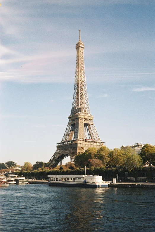 the eiffel tower towering over the city from across the river