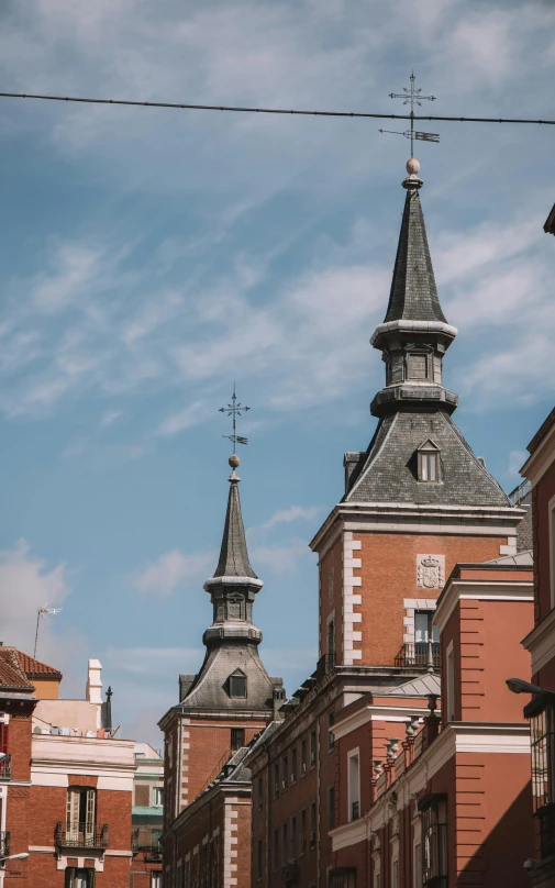 tall buildings with an ornate clock tower and sky in the background