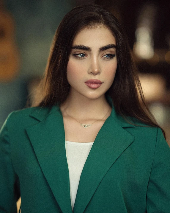 a close - up of a woman in a green blazer