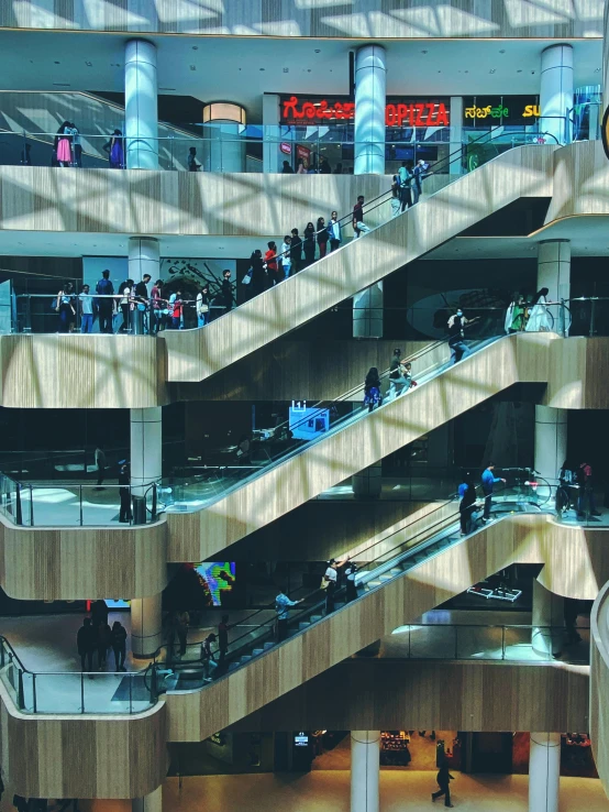 several people walk on an escalator in a city