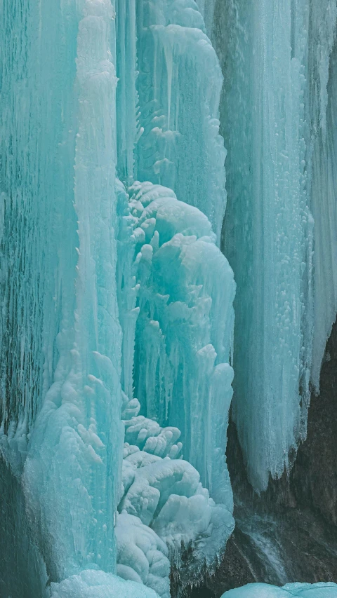 some ice is hanging off of a wall