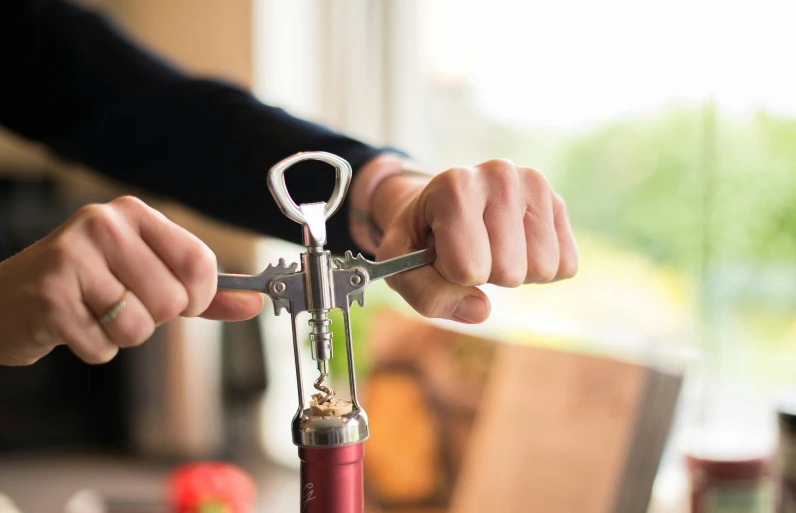 a person holding a pair of scissors while doing soing