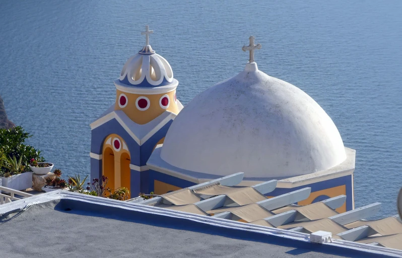 an elaborately painted building by the water is seen from above