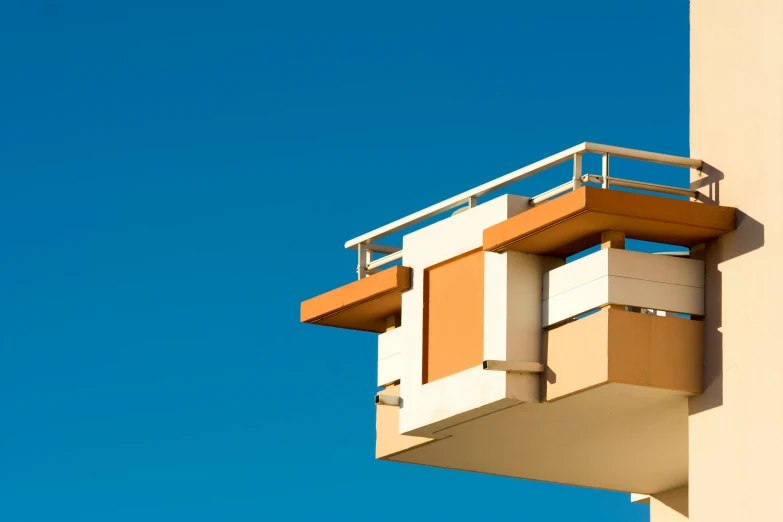 a white and tan building on a clear day