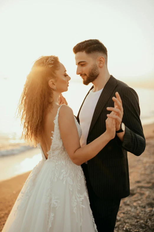 a young man is holding a woman's hand and looking at him while he is hugging his back