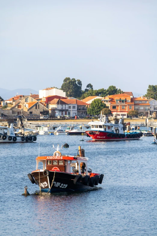 small boats float in the water by some houses