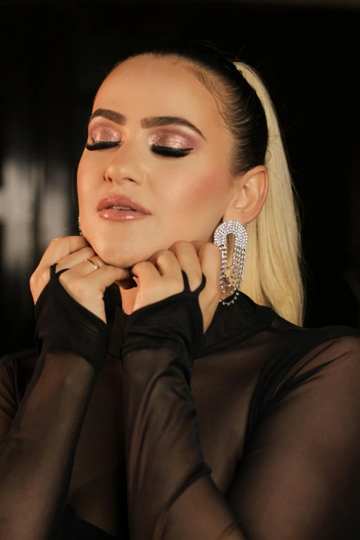woman wearing shiny gold and black makeup