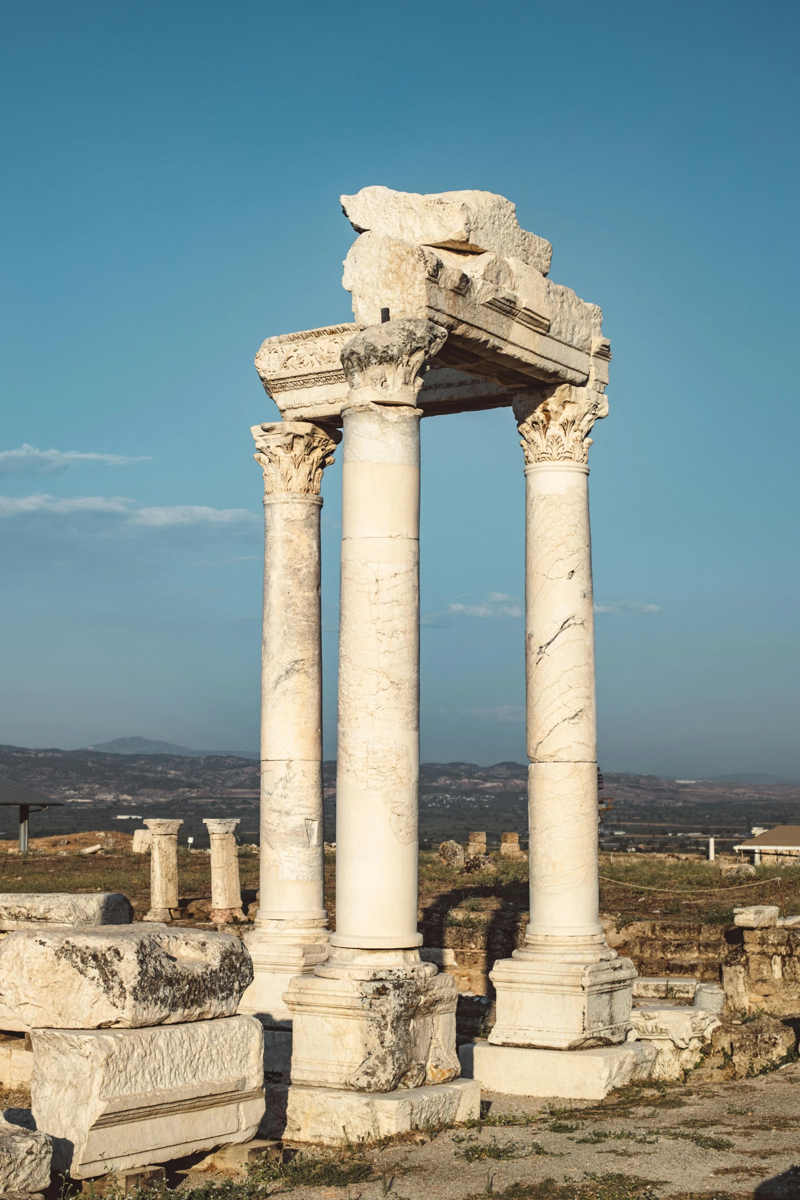 an old ruins with two large pillars and two large columns