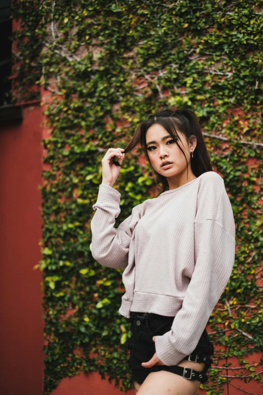 young woman wearing black shorts with crop top on top