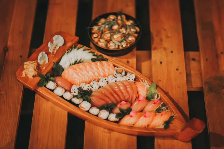 an overhead view of a wooden boat filled with sushi
