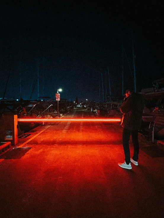 a person standing in the street with some red lights