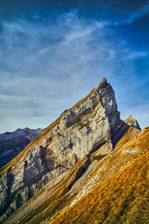 a small rock formation on a grassy plain