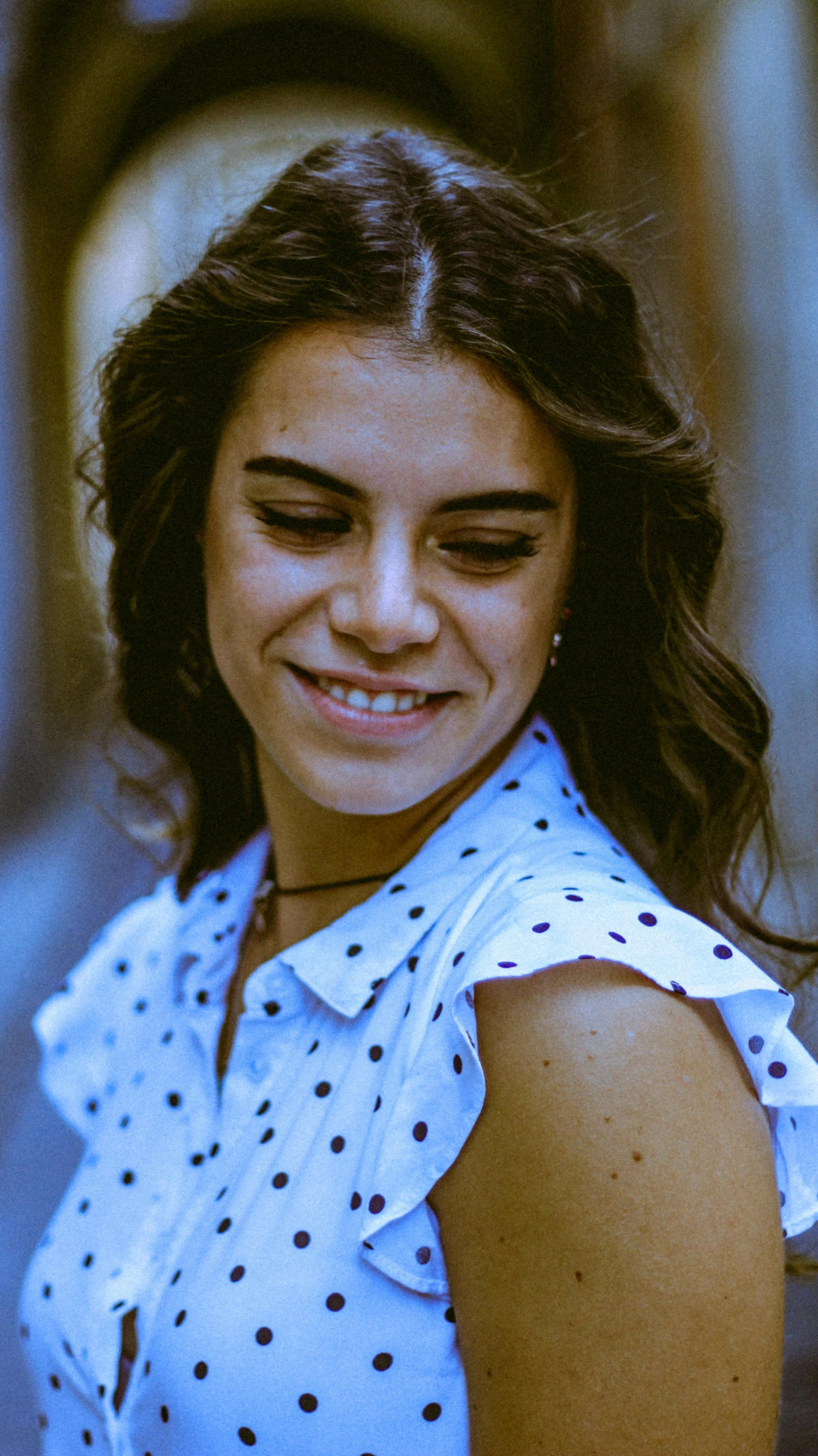 a woman smiles at the camera while wearing her dress