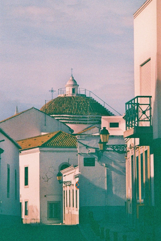 the roof of a building with a cross on top