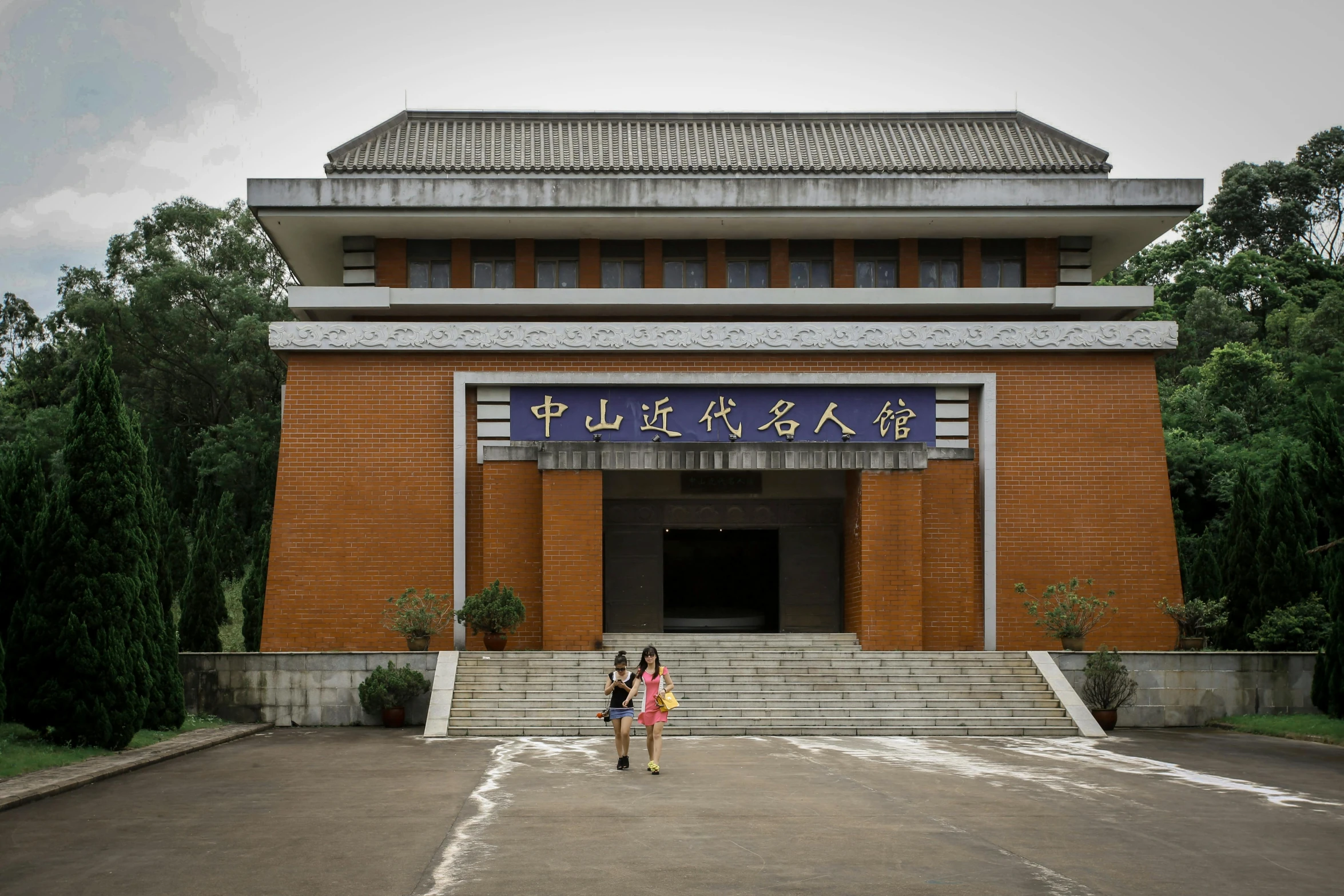 two children are outside a very tall building