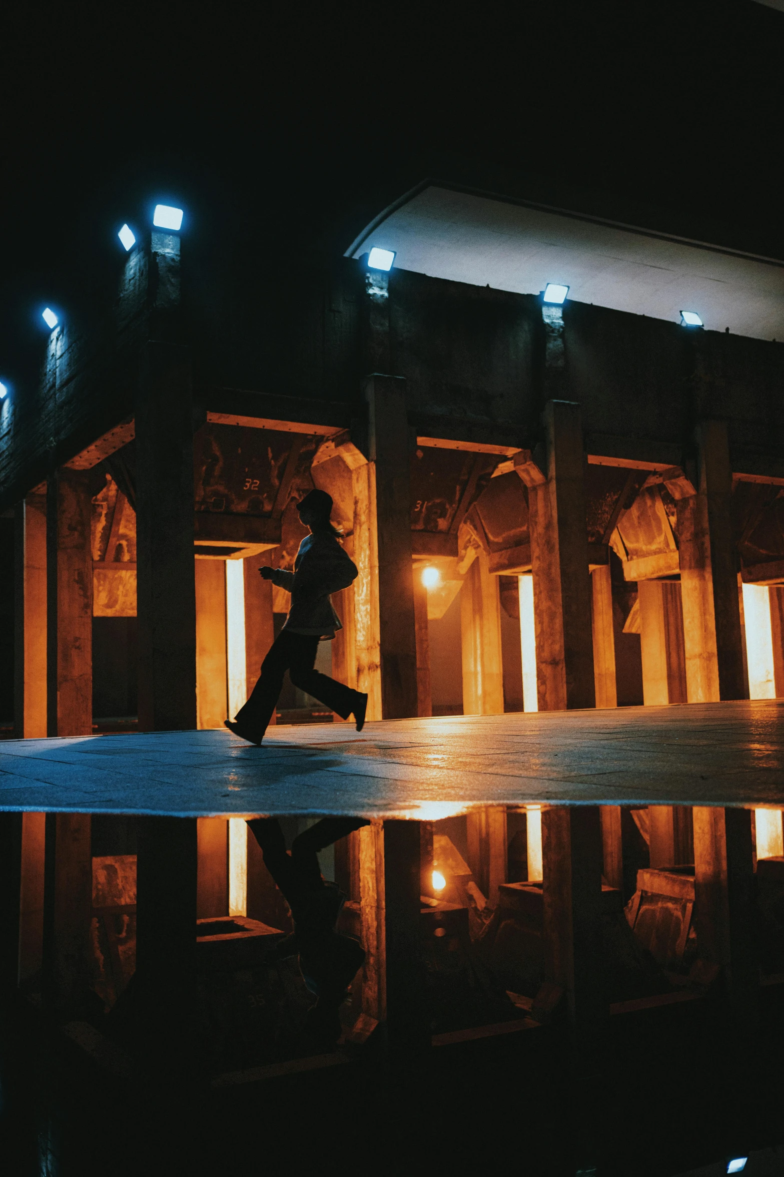 there is a male model on stage in front of a mirrored surface