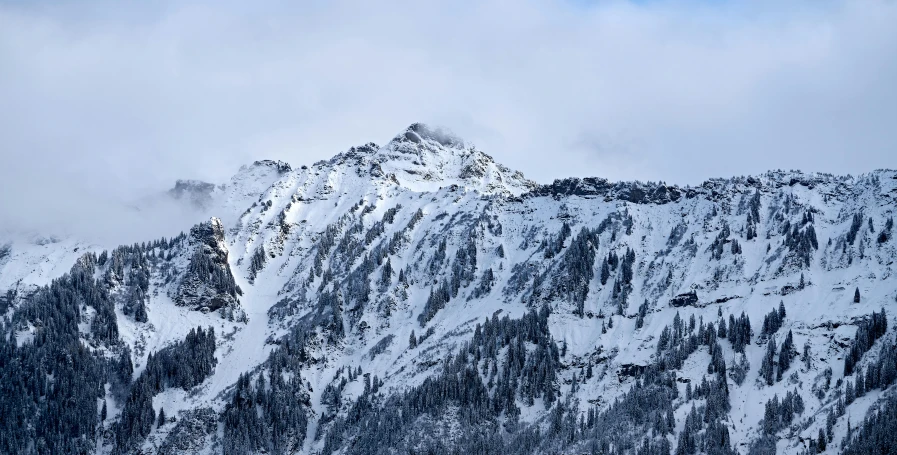 a very tall mountain with snow covering the top