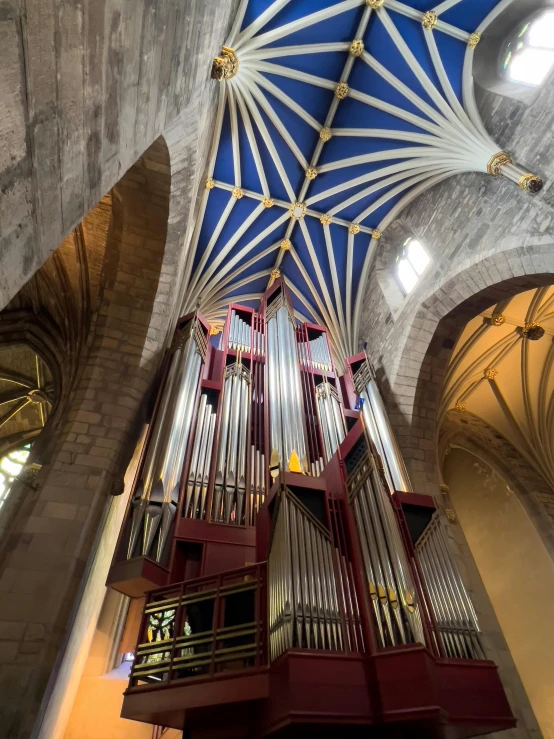 a pipe organ in a church with exposed ceiling