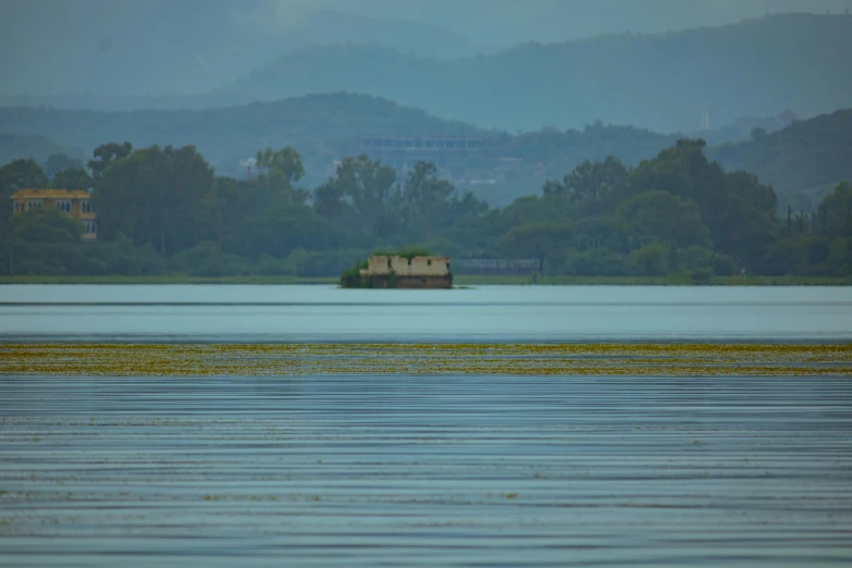 the lone house is on the small island in the middle of the lake