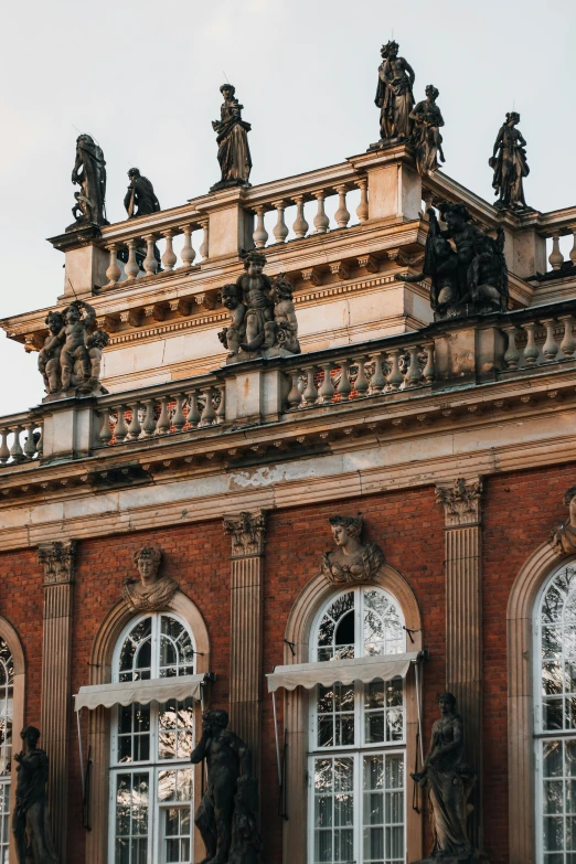 an old building with ornate windows and statues on top