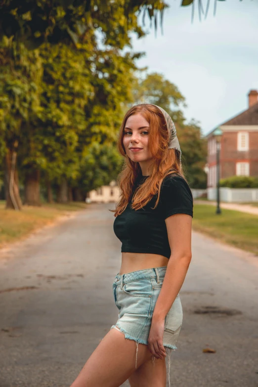 a woman posing on the road in shorts