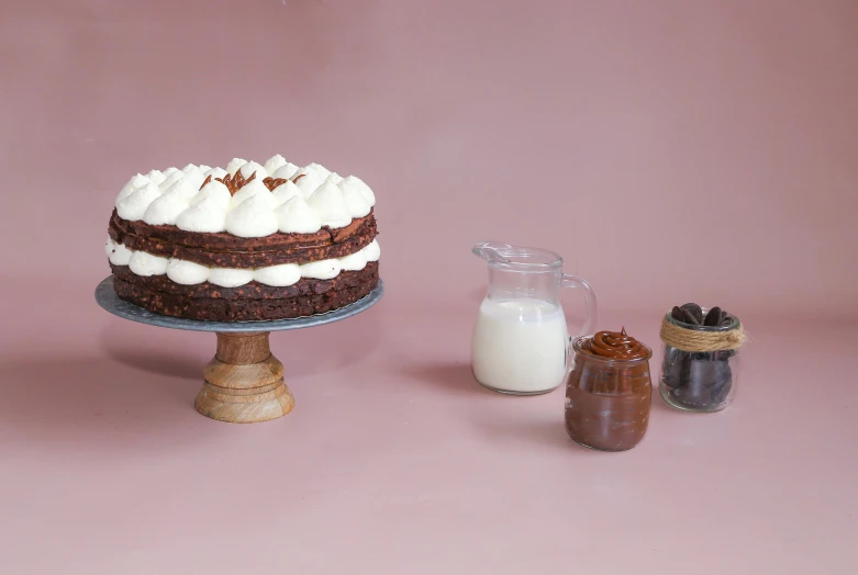 a dessert on a cake stand is shown with milk