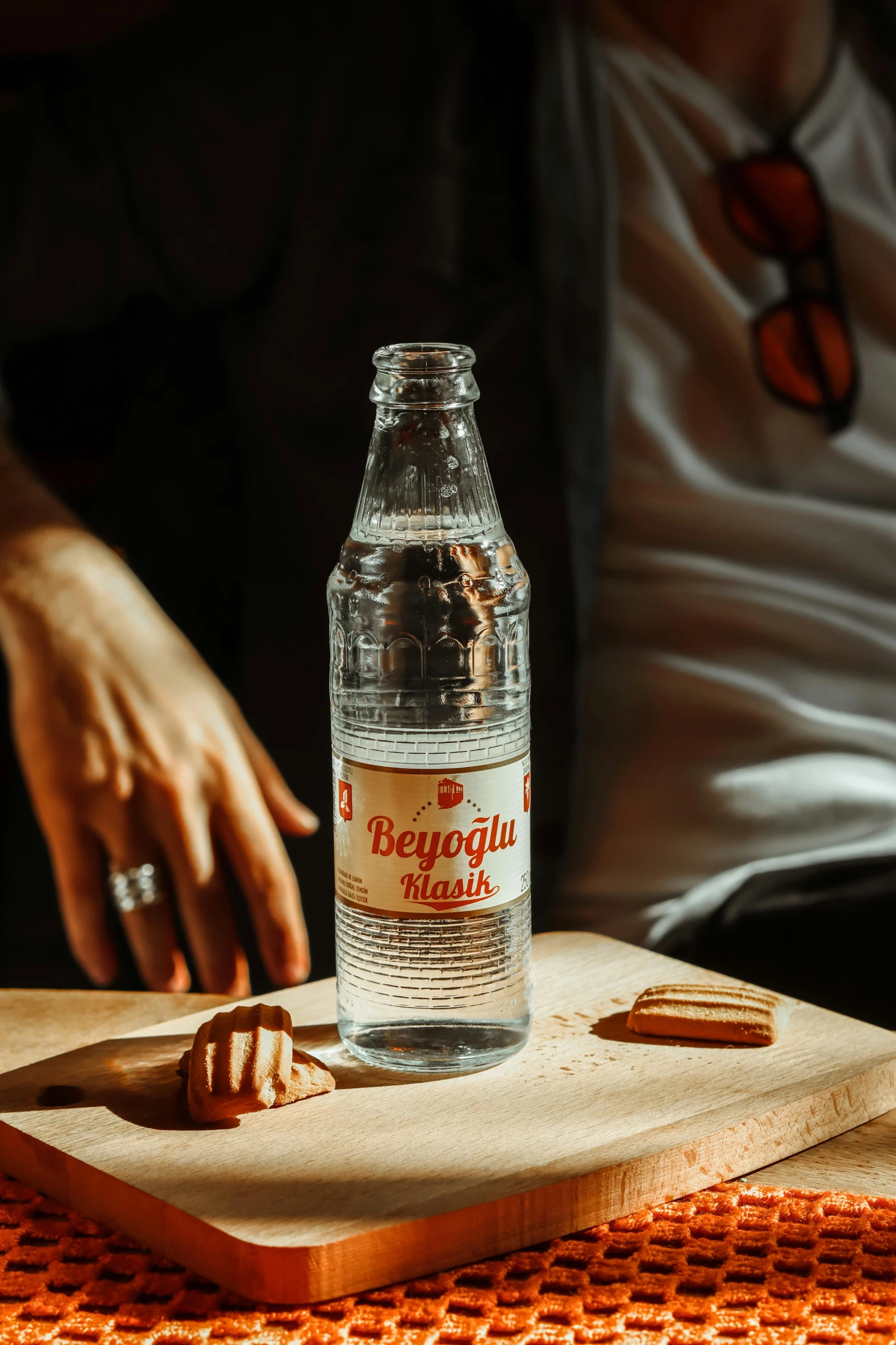 a bottle of alcohol is sitting on a  board