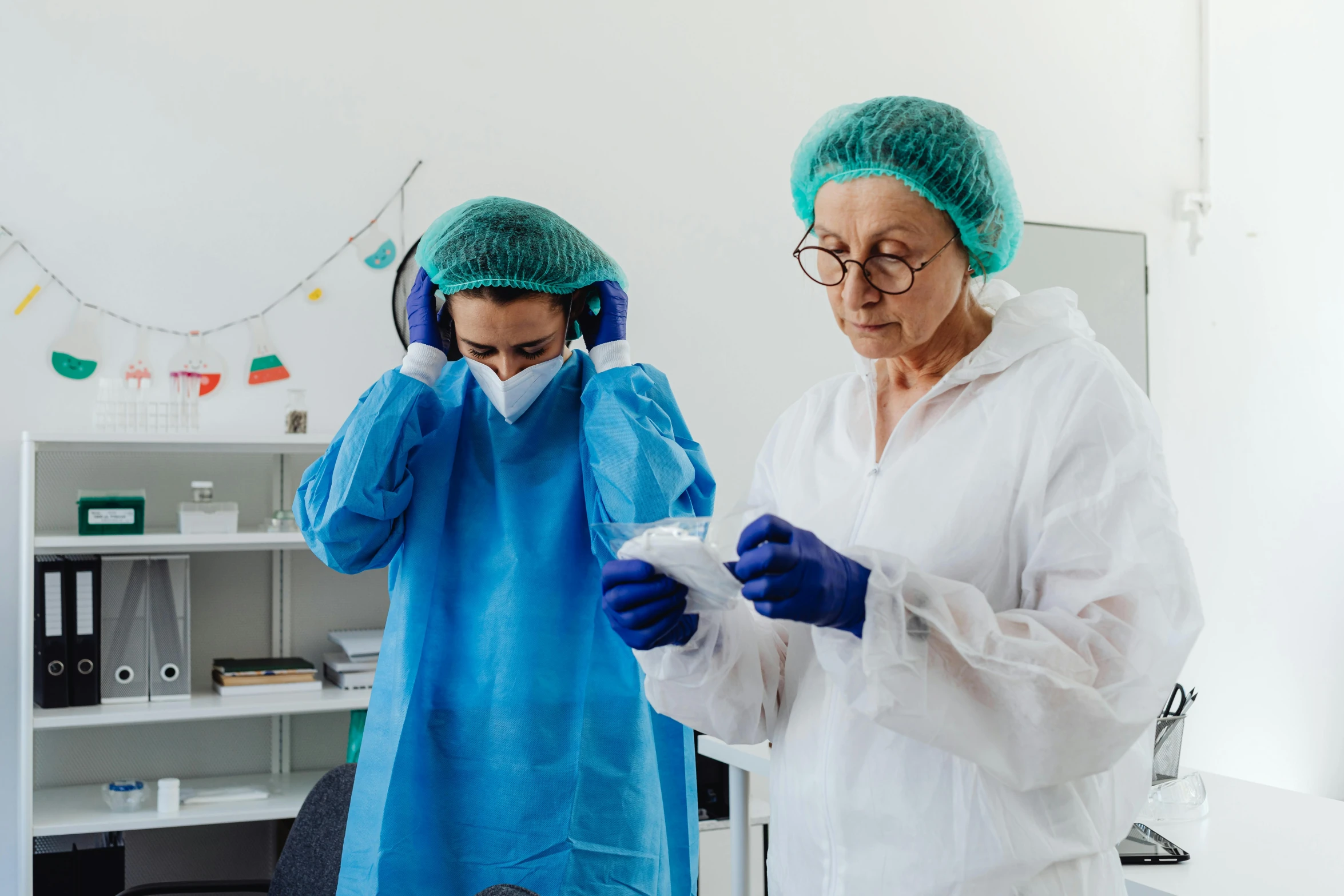 two women in sterile clothing working on some type of device