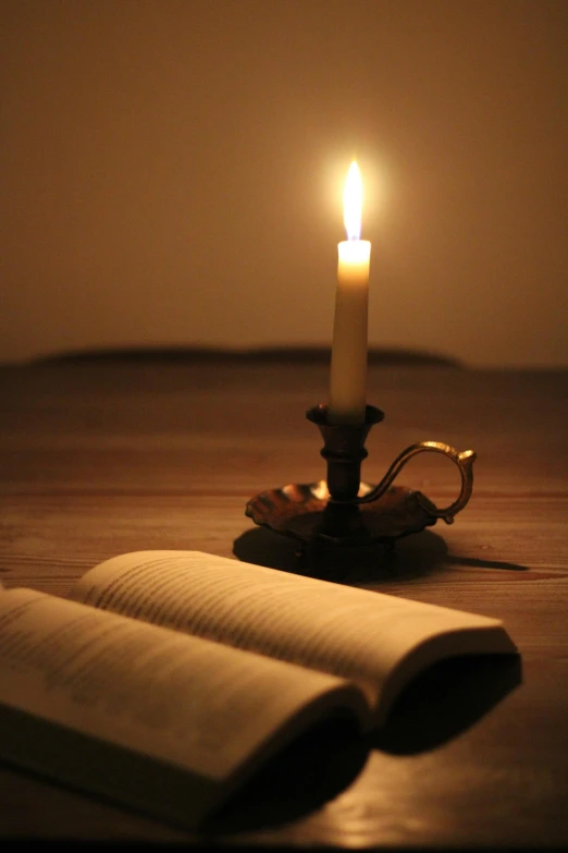 a single candle sitting on top of a table