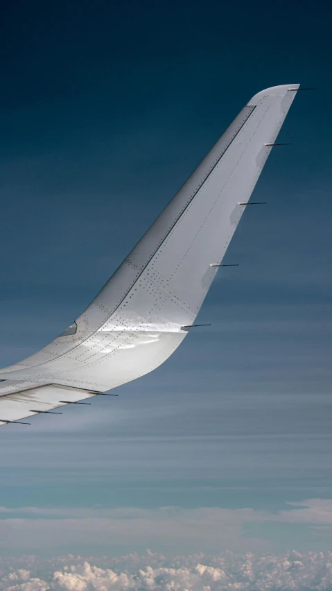 the tail of a large passenger jet in the sky